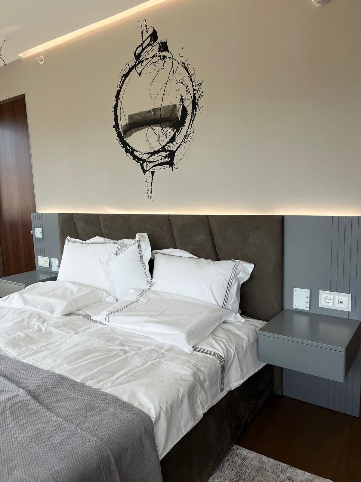 Upholstered headboard with wall art and LED strip
